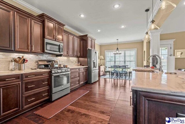 3111 Cheshire Ln, Florence, SC 29501 - kitchen featuring appliances with stainless steel finishes, a sink, ornamental molding, dark wood-style floors, and decorative backsplash