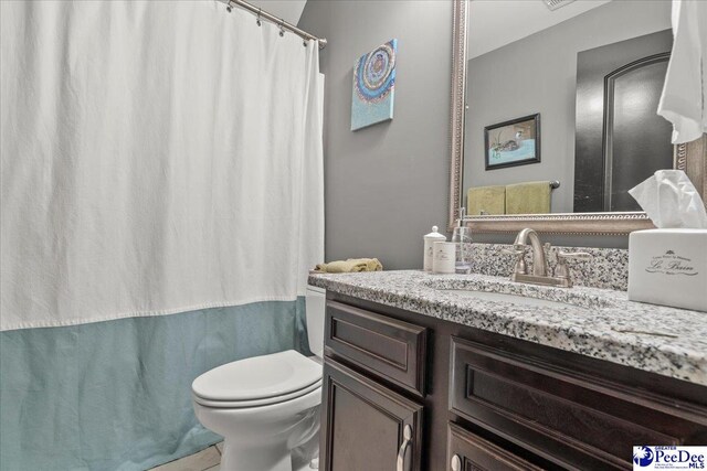 3111 Cheshire Ln, Florence, SC 29501 - bathroom with toilet, vanity, and a shower with shower curtain