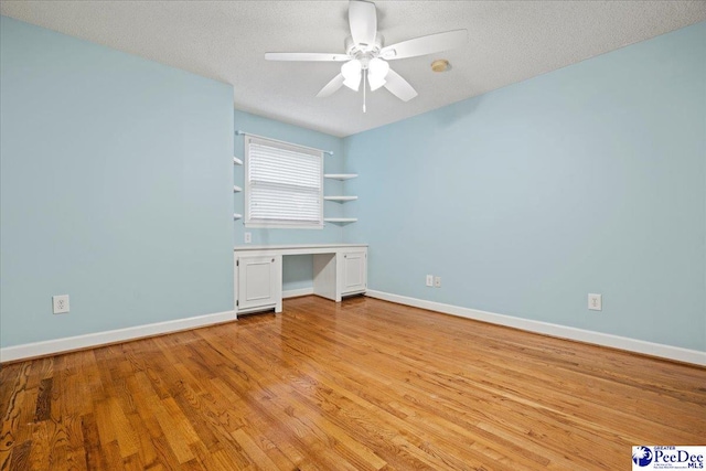 unfurnished bedroom with ceiling fan, light hardwood / wood-style flooring, and a textured ceiling