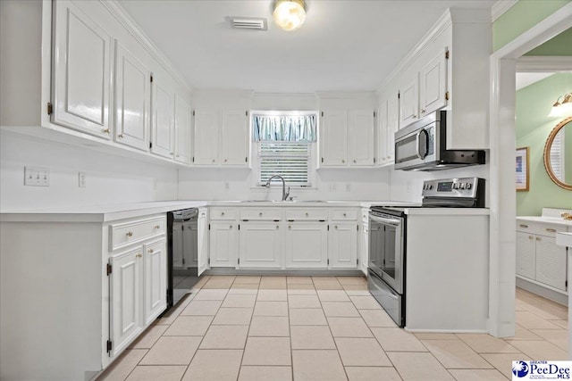 kitchen with appliances with stainless steel finishes, sink, white cabinets, light tile patterned floors, and crown molding