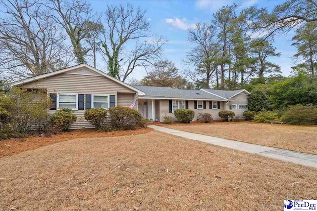 ranch-style home with a front lawn