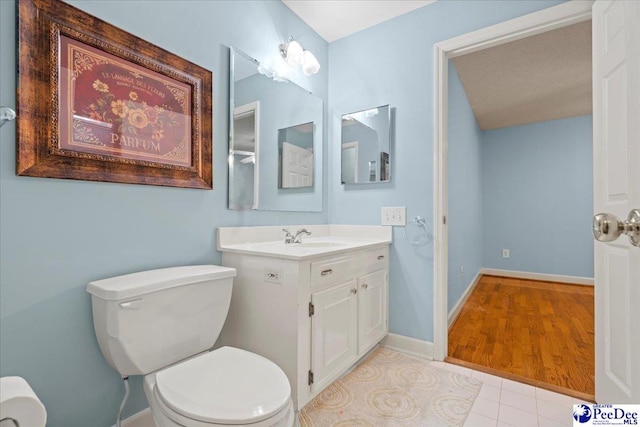 bathroom with vanity, tile patterned floors, and toilet