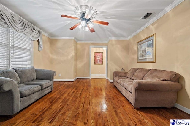 living room with ceiling fan, ornamental molding, and wood-type flooring