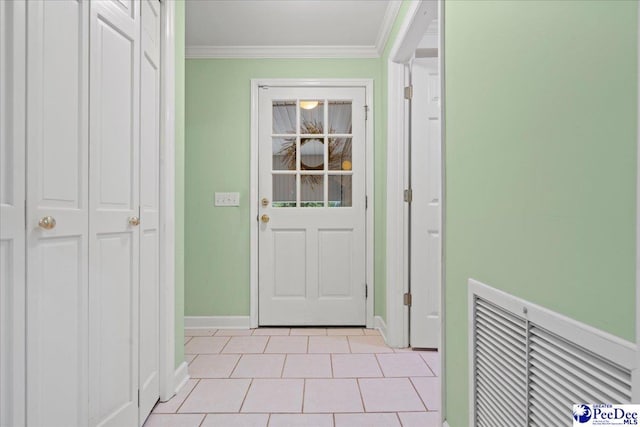 doorway featuring crown molding and light tile patterned flooring