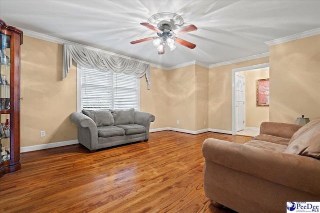 living room with crown molding, ceiling fan, and wood-type flooring