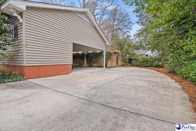 view of property exterior featuring a carport