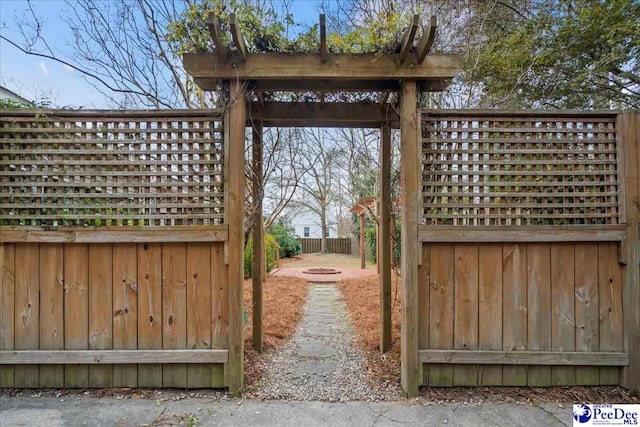 view of gate with an outdoor fire pit