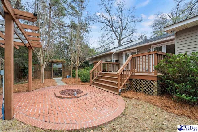 view of patio with a wooden deck and an outdoor fire pit