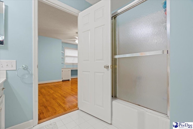 bathroom featuring vanity, tile patterned floors, enclosed tub / shower combo, and ceiling fan