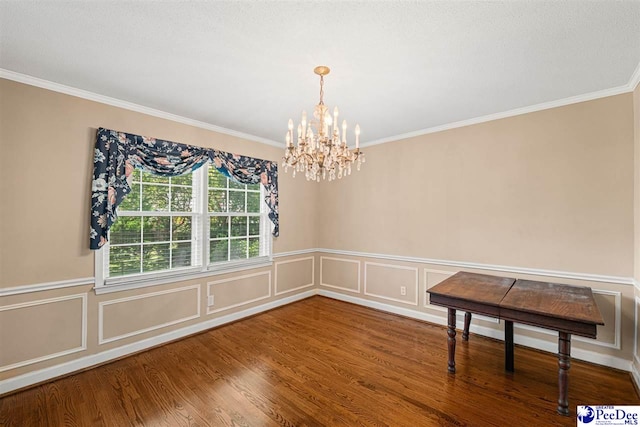 1110 Dunvegan Rd, Florence, SC 29501 - unfurnished dining area with a chandelier, crown molding, wood finished floors, and wainscoting