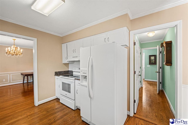 1110 Dunvegan Rd, Florence, SC 29501 - kitchen with white appliances, wood finished floors, ornamental molding, white cabinetry, and under cabinet range hood
