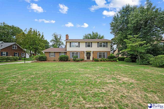 1110 Dunvegan Rd, Florence, SC 29501 - colonial-style house with brick siding, a chimney, and a front lawn