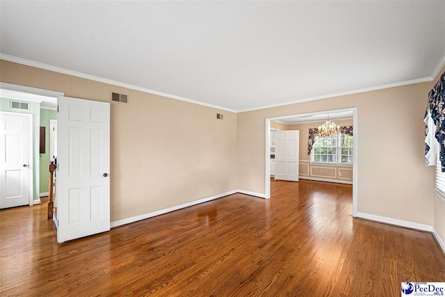 1110 Dunvegan Rd, Florence, SC 29501 - spare room featuring a chandelier, wood finished floors, and crown molding