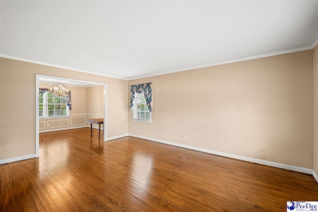 1110 Dunvegan Rd, Florence, SC 29501 - spare room with a chandelier, ornamental molding, and wood finished floors