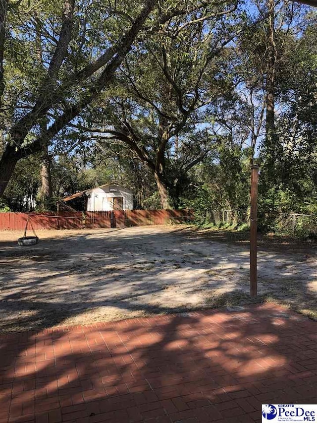 view of road featuring decorative driveway