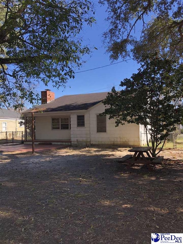 exterior space with a chimney and fence