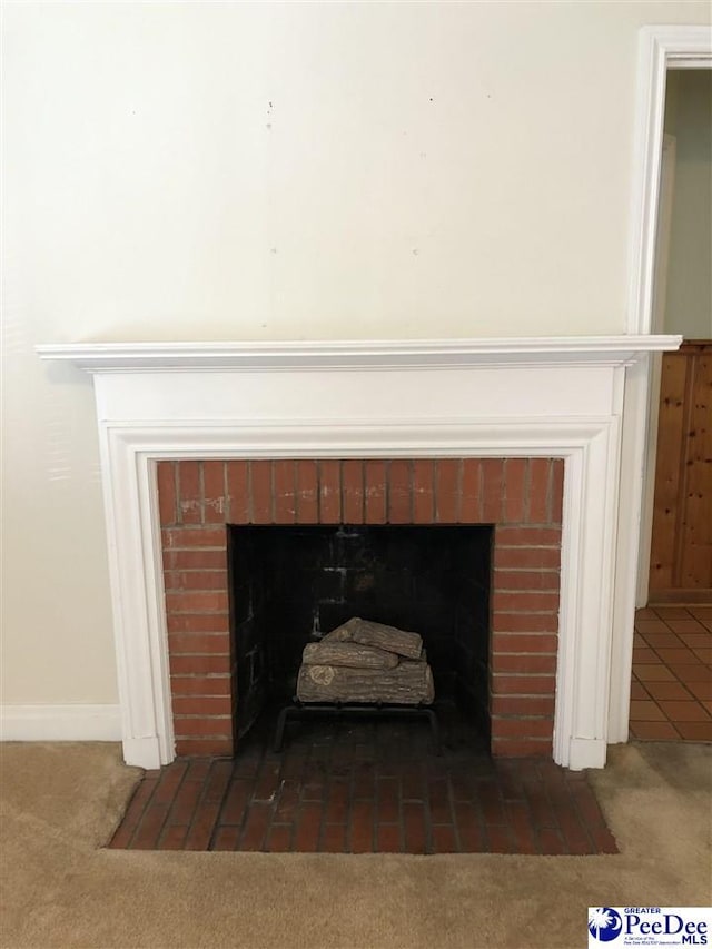 room details featuring carpet, a fireplace with flush hearth, and baseboards