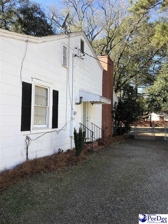 view of property exterior with a chimney