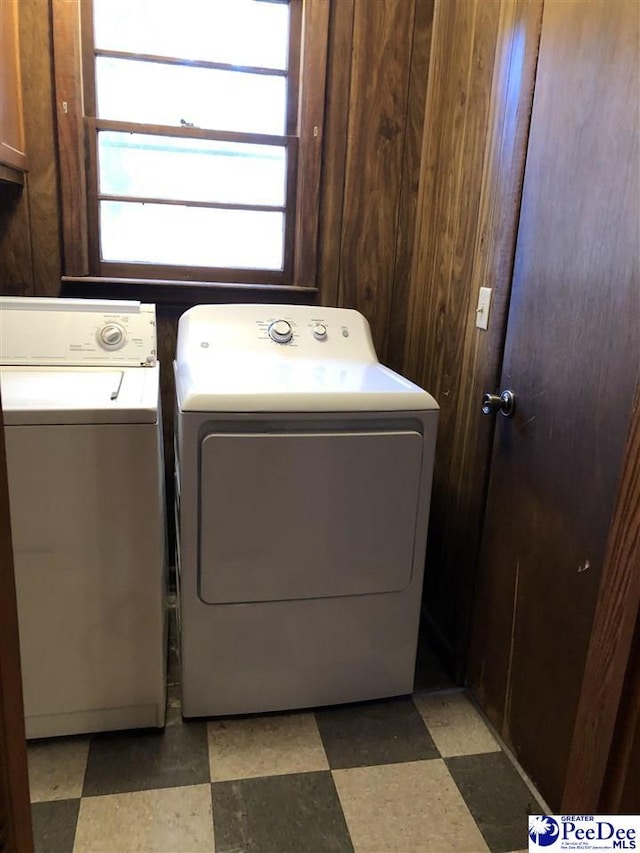 washroom with light floors and washing machine and clothes dryer