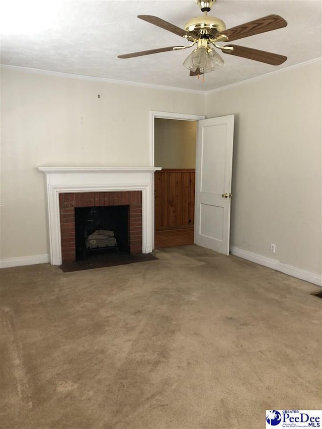 unfurnished living room featuring ceiling fan, carpet floors, baseboards, ornamental molding, and a brick fireplace