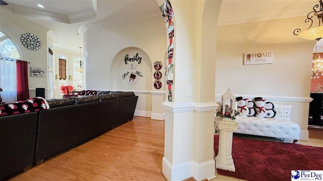 living room featuring hardwood / wood-style flooring and ornamental molding