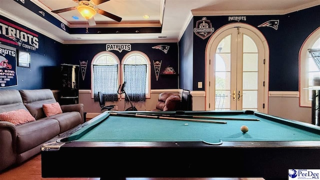 rec room featuring billiards, ceiling fan, a tray ceiling, ornamental molding, and french doors