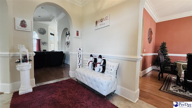 interior space with hardwood / wood-style floors and crown molding