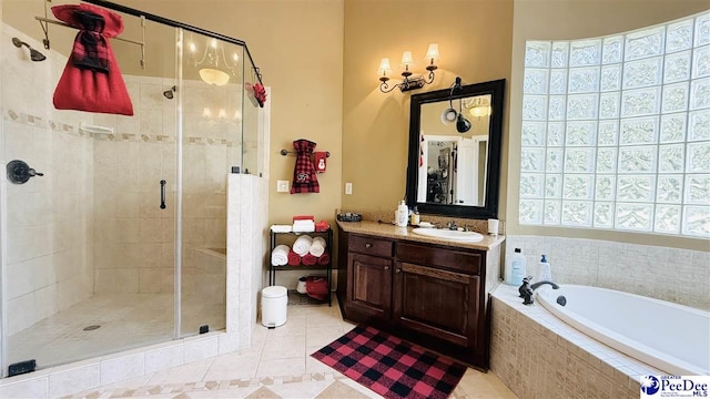 bathroom with tile patterned flooring, plus walk in shower, and vanity