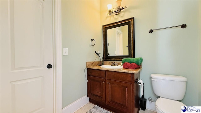 bathroom featuring tile patterned floors, vanity, and toilet