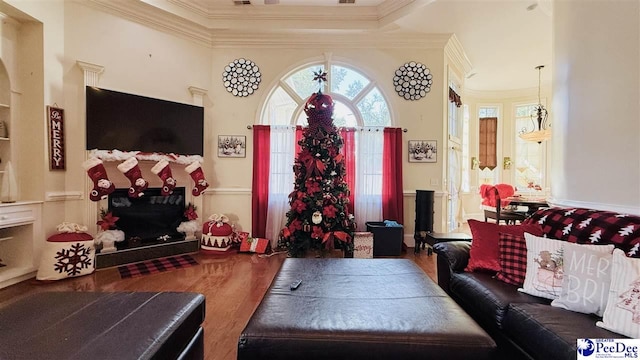 living room with wood-type flooring and ornamental molding