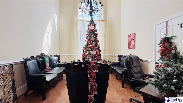 home office with hardwood / wood-style flooring and a notable chandelier