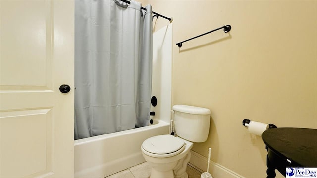 bathroom featuring toilet, tile patterned flooring, and shower / bath combo with shower curtain