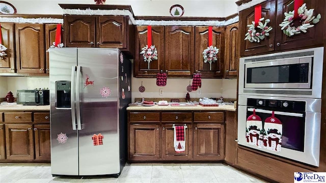 kitchen featuring stainless steel appliances and dark brown cabinetry