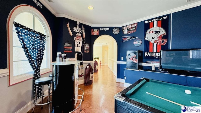 rec room featuring ornamental molding and wood-type flooring