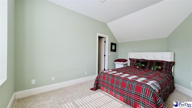bedroom featuring vaulted ceiling and carpet