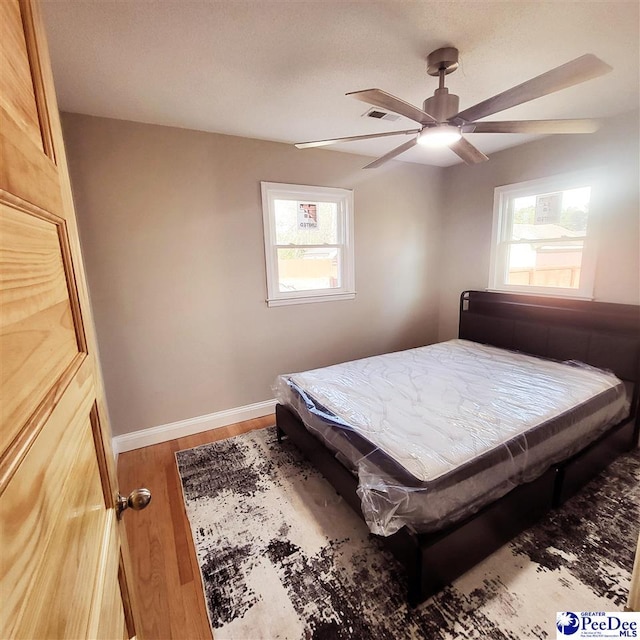 139 Wingate Ave, Florence, SC 29506 - bedroom with a ceiling fan, visible vents, baseboards, and wood finished floors