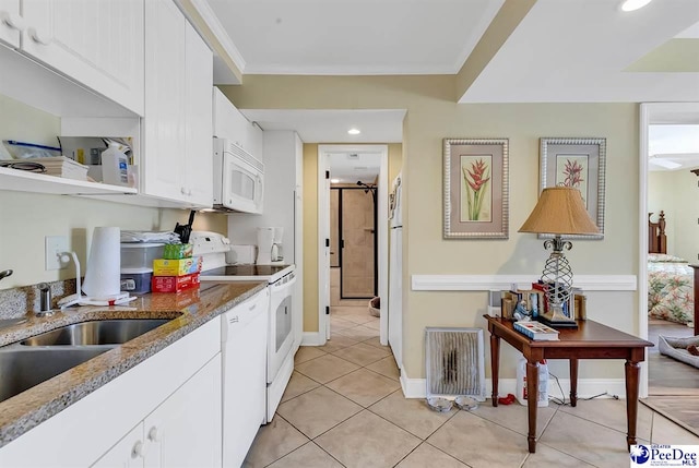kitchen with light stone countertops, white appliances, white cabinetry, recessed lighting, and light tile patterned floors