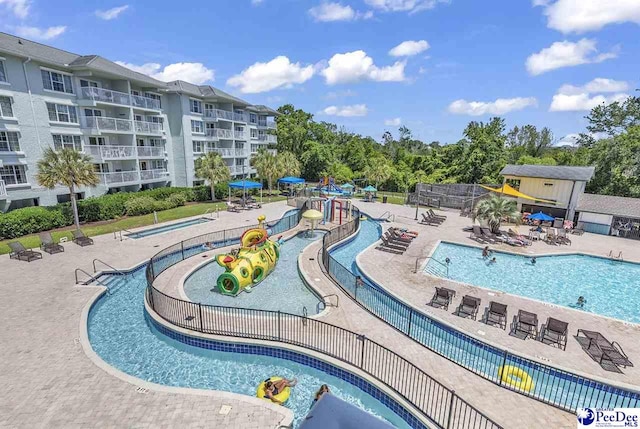 community pool featuring a patio area and fence