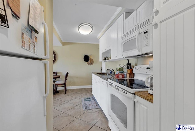 kitchen with crown molding, dark countertops, a sink, white appliances, and white cabinetry