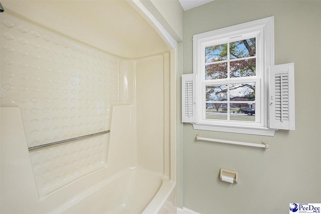 bathroom featuring a healthy amount of sunlight and tub / shower combination