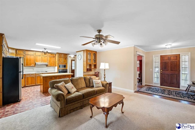 living room with light carpet, ceiling fan, ornamental molding, and a healthy amount of sunlight