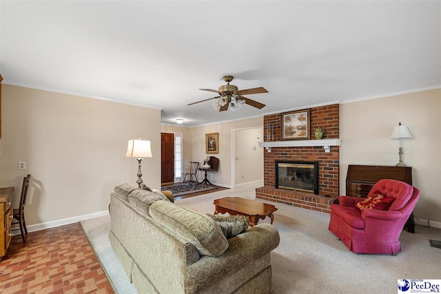 living room featuring a brick fireplace, ornamental molding, and ceiling fan