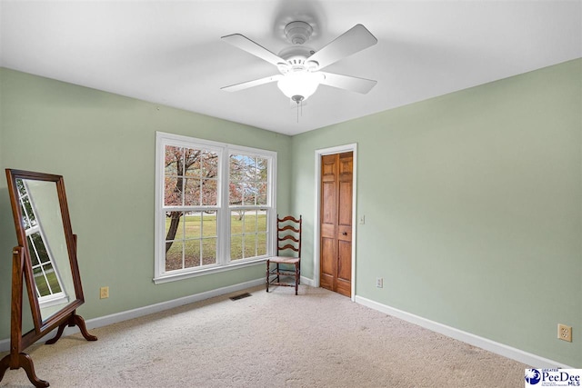 interior space with ceiling fan and carpet flooring