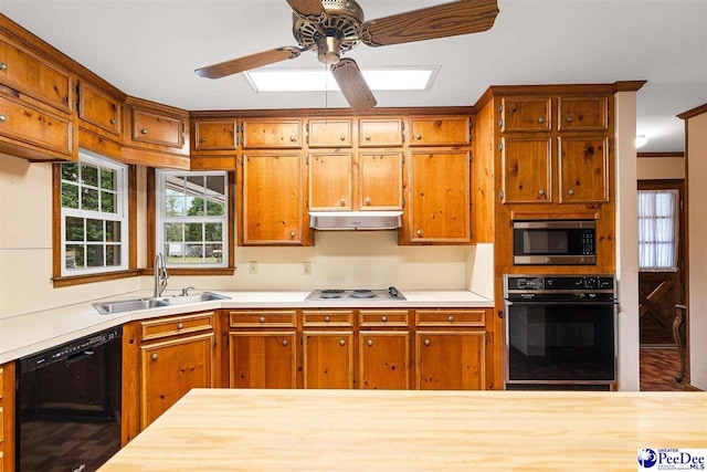 kitchen with sink, ornamental molding, black appliances, and ceiling fan