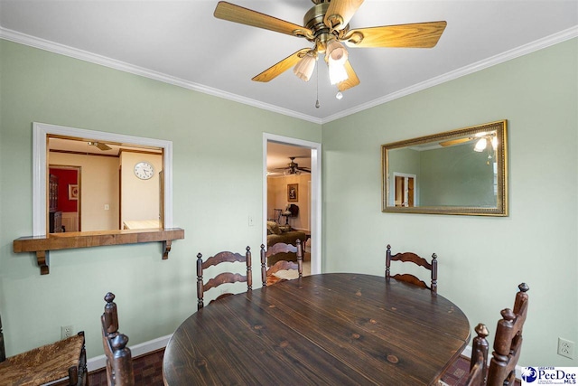 dining space featuring ceiling fan and ornamental molding