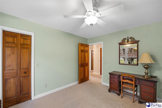 home office featuring ceiling fan and light colored carpet