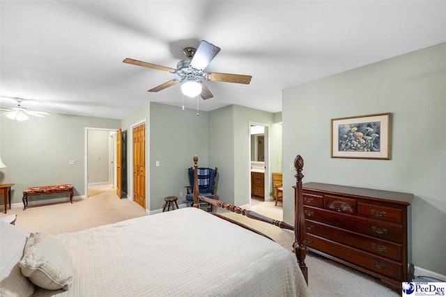 carpeted bedroom with ceiling fan and ensuite bathroom