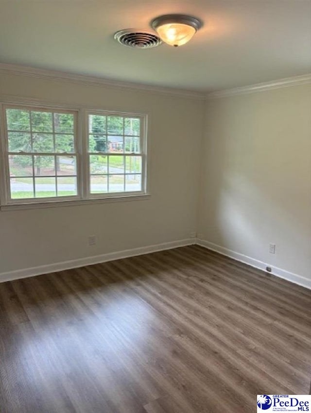 507 Arbor Dr, Florence, SC 29501 - spare room featuring healthy amount of natural light, crown molding, baseboards, and dark wood-style floors