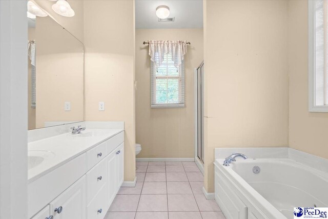 bathroom featuring visible vents, tile patterned flooring, toilet, a bath, and a sink
