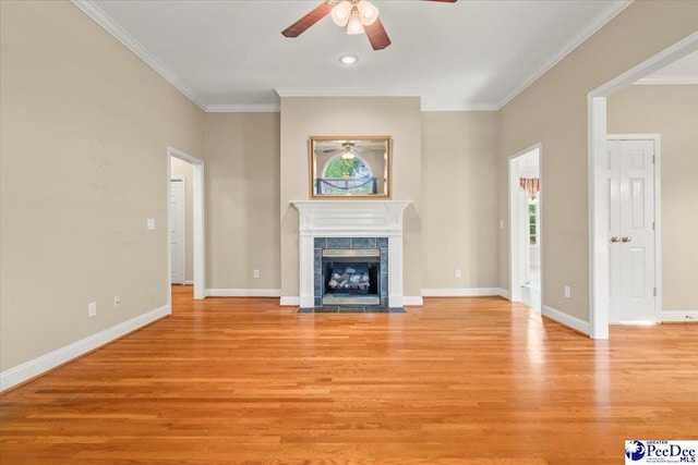unfurnished living room featuring crown molding, ceiling fan, and light wood finished floors